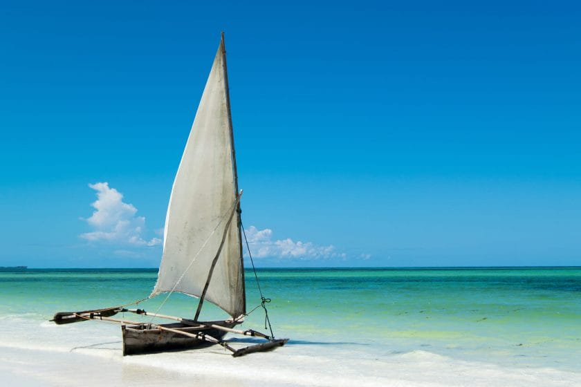 Boat on white sand beach in Zanzibar
