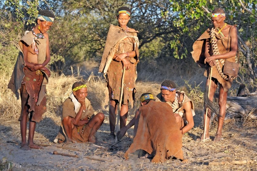 San bush people gather in the setting sun, Makgadikgadi Pans, Botswana, Southern Africa