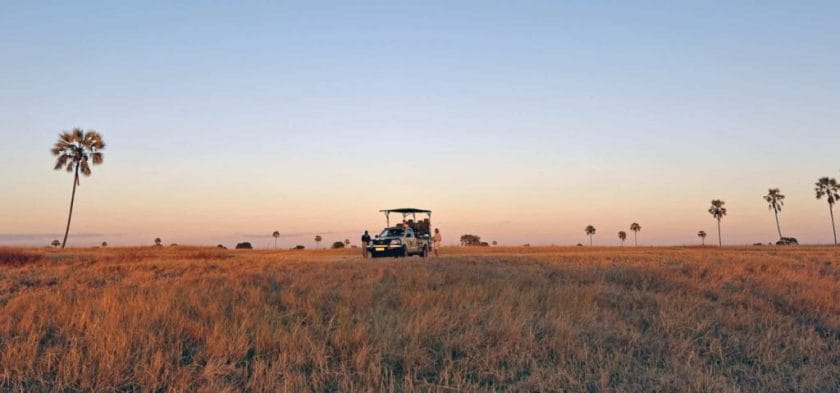 A safari vehicle at sunset on the Makgadikgadi Pans, Botswana, Southern Africa