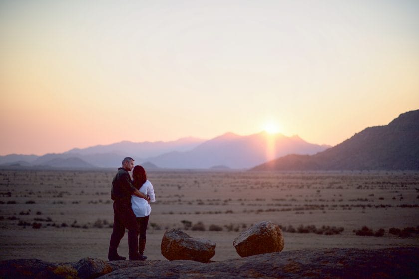 Couple holding each other at sunset