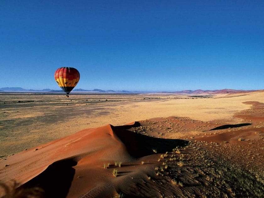 Hot air balloon flying above the desert in Namibia.