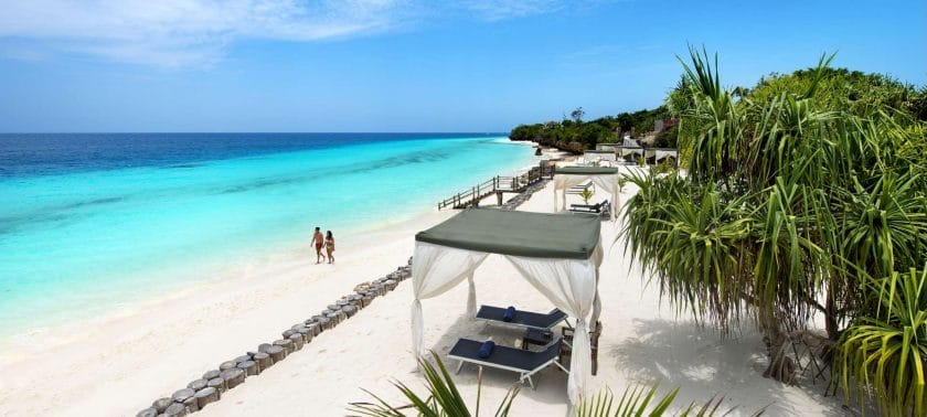 A couple strolls along one of Mauritius' many luxury resorts