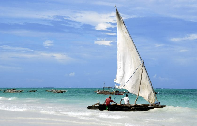 Fishermen and their dhow, Kiwengwa Beach, Zanzibar.