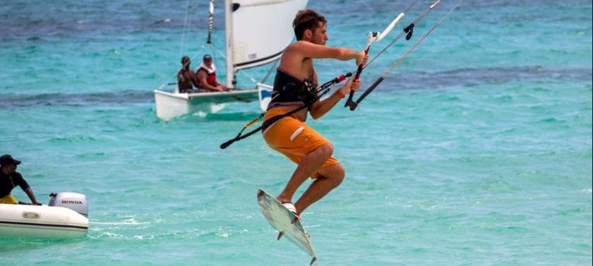 Kitesurfing over tropical waters.