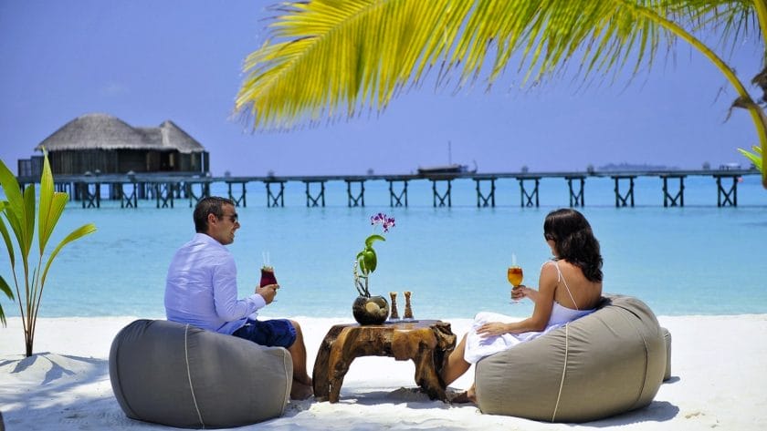 Couple enjoying cocktails on an Island holiday