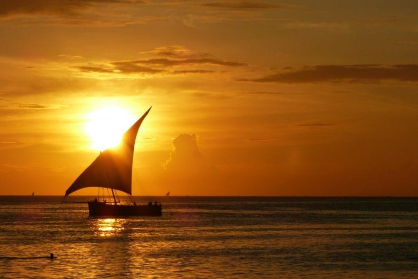 Boat sailing in sunset near Stone Town, Zanzibar.