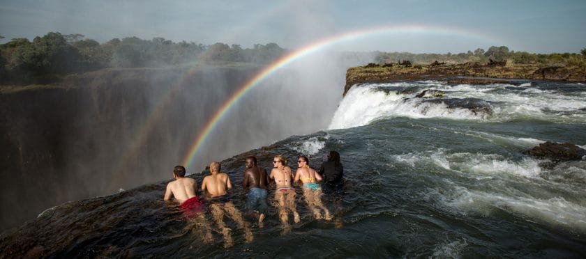 Tourists on the edge of Devil's Pools in Victoria Falls.