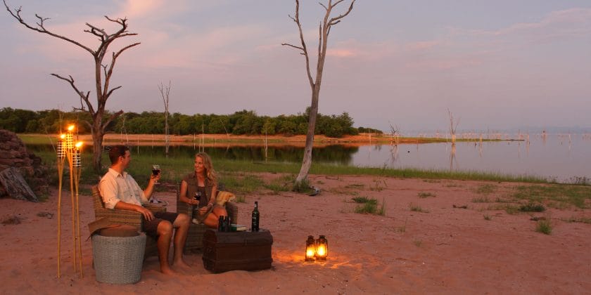 Couple on honeymoon enjoying sundowner drinks at Lake Kariba in ZImbabwe | Photo credit: Changa Safari Camp