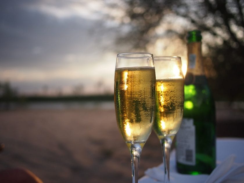 Champagne glasses and bottle on a luxury sunset safari