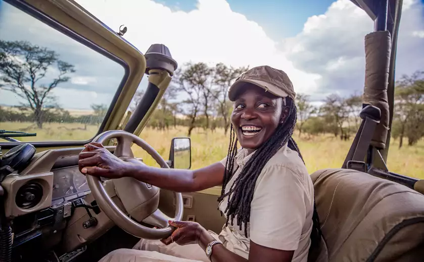 Safari guide Zawadi drives out of Dunia Camp, Tanzania | Photo credit: Asilia Africa