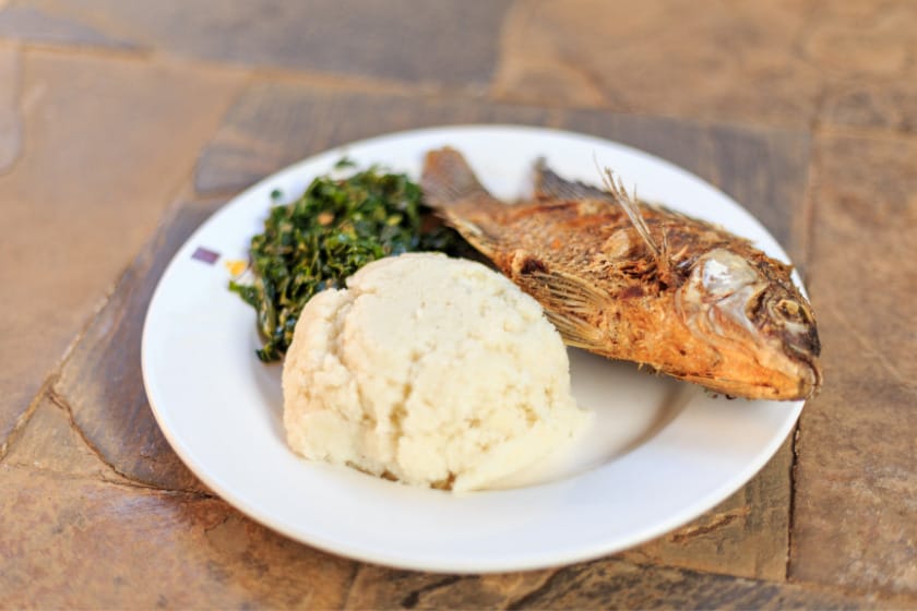 Plate of Posho or Ugali with some fish and greens