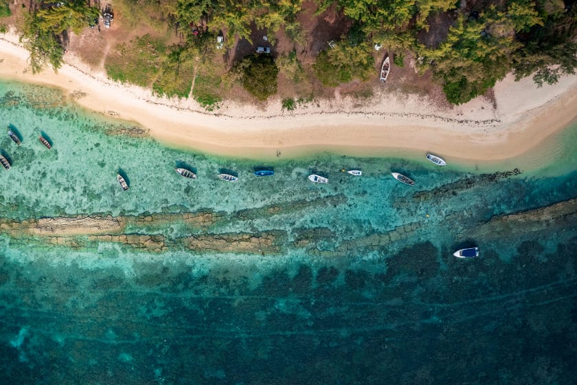 Aerial view of some boats in the water at La Cuvette Beach in Mauritius