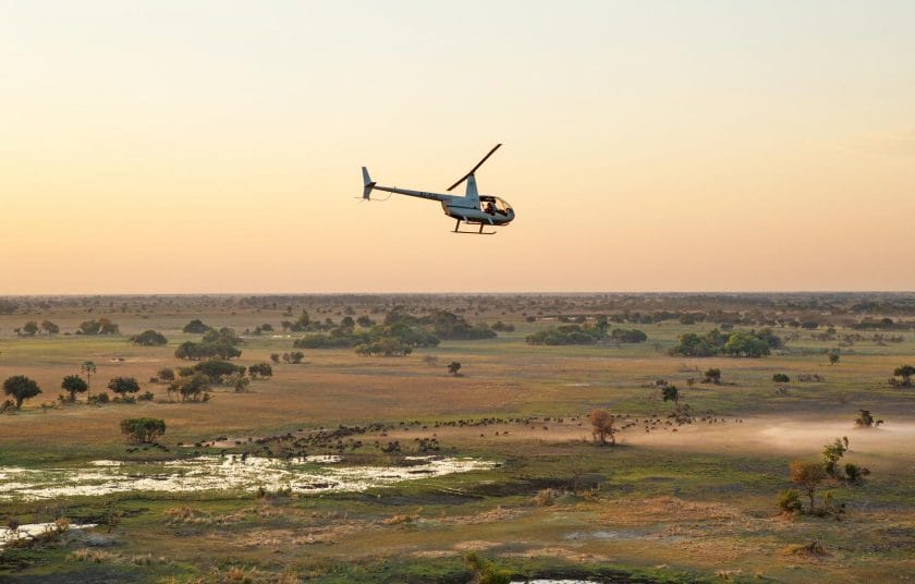 Helicopter flies over the Okavango Delta, Botswana.