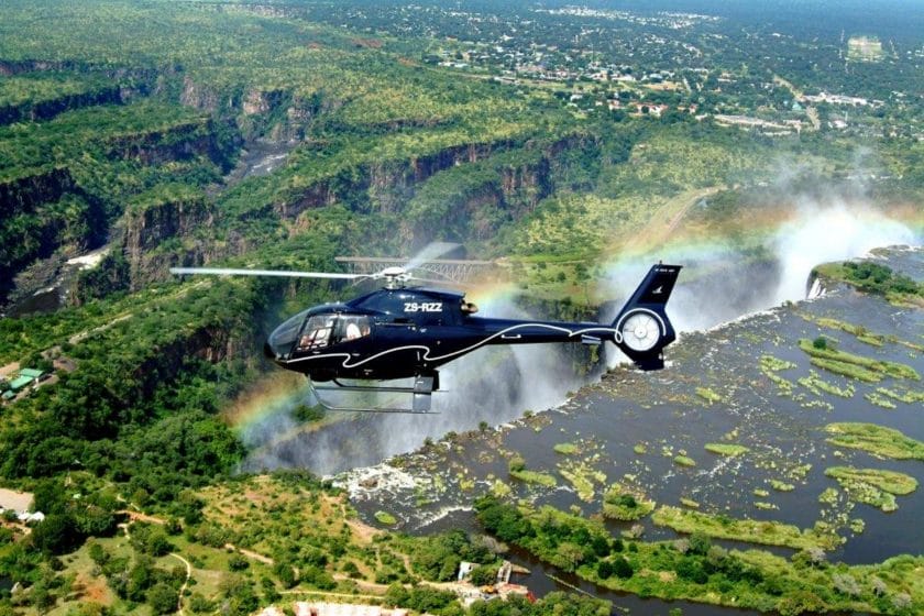 Helicopter flies over Victoria Falls.