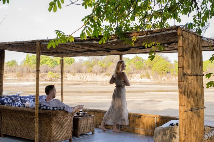 Two people observing the landscape at Kaingo Camp in South Luangwa, Zambia